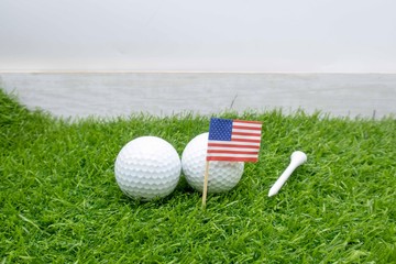 Golf ball with U.S.A. Flag on green with tee