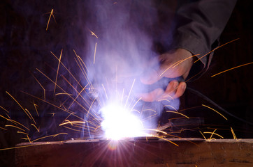 Mans hand with welding machine