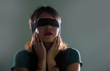 young scared and blindfolded Asian Chinese teenager girl lost and confused playing dangerous...