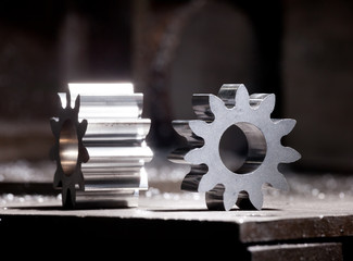 closeup of metal engine detail - steel gear on industrial background