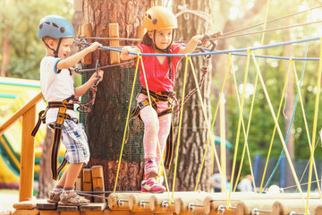 Cute little children playing with rope outdoors on sunny day © Angelov