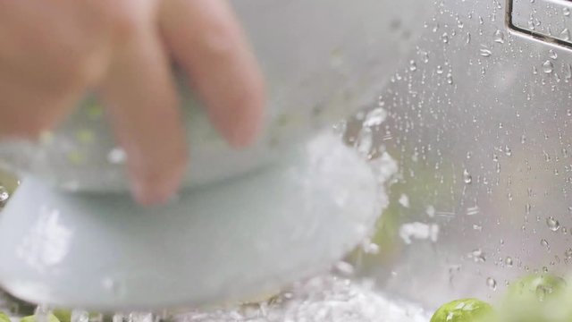washing raw Brussels sprouts in kitchen sink