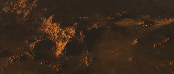 Bare mountains with trees in evening sunlight. Aerial view.