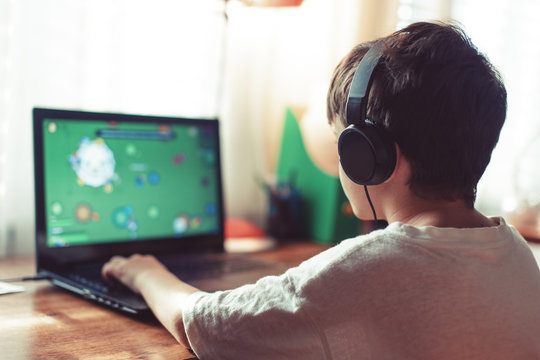 Little Dependent Gamer Boy Playing On Laptop