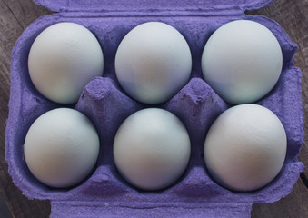 Six white eggs in egg tray box