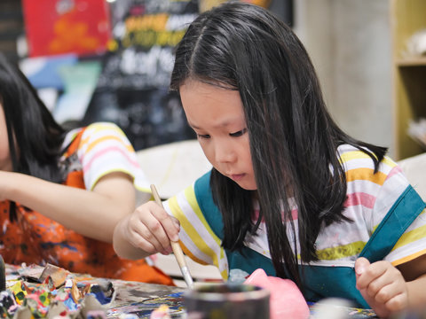 Asian Girl Painting Plaster Mask In Artist Workshop, Lifestyle Concept.