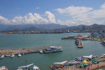 Fototapeta na wymiar Batumi Sea Port with boats. Moorage for boats. View From Ferris wheel Of Embankment Of The Georgian Resort Town