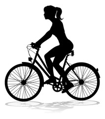 A woman bicycle riding bike cyclist in silhouette