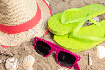 flip flops with sunglasses and strand hat