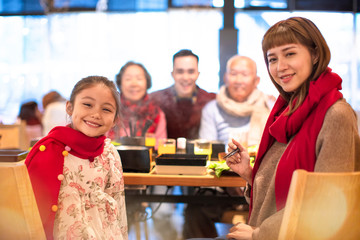happy asian family having dinner and celebrating chinese new year