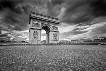Fototapeta na wymiar Dark Clouds coming over the Arc de Triomphe in Paris, France