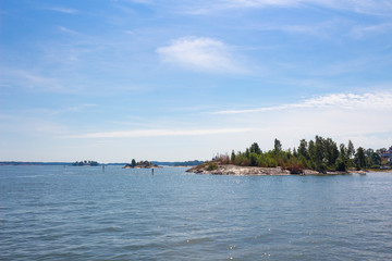 Fototapeta na wymiar View of small islands in the Gulf of Finland near the city of Helsinki in Finland on a summer day. Ferry trip around the Gulf of Finland.