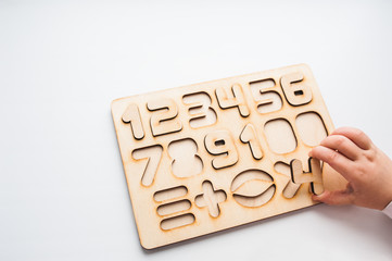 Wooden puzzle with numbers and arithmetic signs