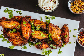 Spicy Chicken Wings with Cilantro, White Sauce and Chili Flakes