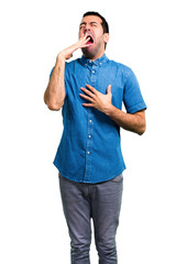 Handsome man with blue shirt yawning