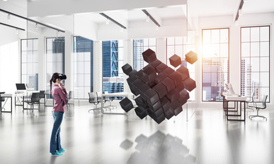 Girl in virtual reality mask experiencing virtual technology wor