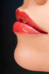 cropped view of female red lips isolated on black