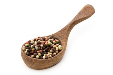 Pepper mix seed on spoon on white background.