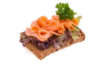 Bread with fresh salmon fillet isolated on white background, top view.