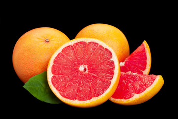 orange and grapefruit on black background