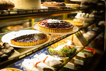 Coffee shop window full of sweet confectionery.