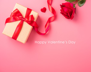 Kraft Gift box with beautful red ribbon and rose, concept of Valentine's, anniversary, mother's day and birthday greeting, copy space, top view.