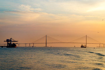 Fototapeta na wymiar Scenery with Incheon Bridge and ship. Beautiful sea bridge. Incheon Bridge with sunset.