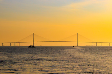 Obraz premium Scenery with Incheon Bridge and ship. Beautiful sea bridge. Incheon Bridge with sunset.