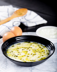 Traditional yayla soup (yoghurt soup) on wooden background