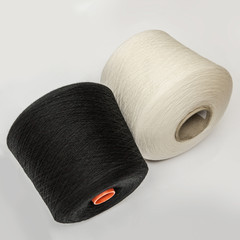 Black and white bobbins of yarn on a white background.