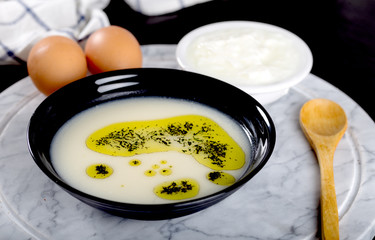 Traditional yayla soup (yoghurt soup) on wooden background