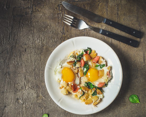 Fried eggs with spinach, sausage and breadcrumbs - healthy breakfast (quick meal). Top view. copy space