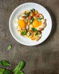 Fried eggs with spinach, sausage and breadcrumbs - healthy breakfast (quick meal). Top view. copy space