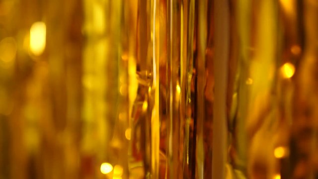 festive long golden tinsel gleams in the light
