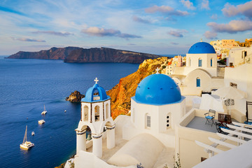 Oia town on Santorini island, Greece with traditional buildings with blue domes