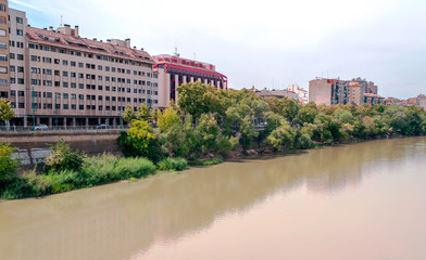 Fototapeta na wymiar Ebro River in Zaragoza with buildings on one side