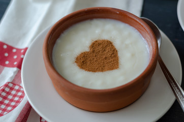 Delicious rice pudding with cinnamon in bowl, closeup