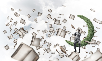 Young man in sky do not want to see anything and books flying ar