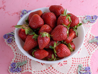 fresh red strawberry in a white ceramic plate