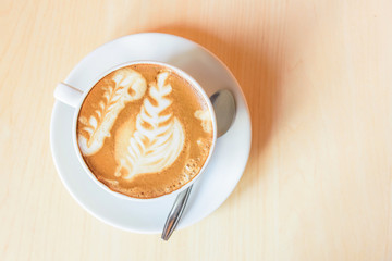 hot cappuccino coffee with nice pattern foam on table / hot coffee