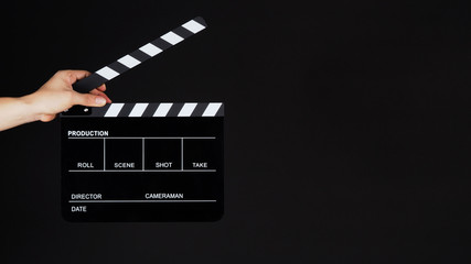 Fototapeta na wymiar Hand's holding Clapperboard or movie slate use in video production ,film, cinema industry on black background.