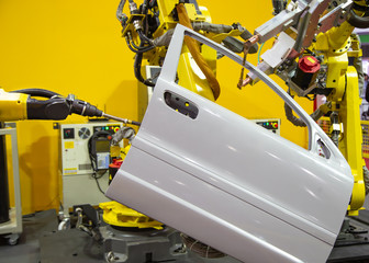 Robot arm demonstrate spot welding car door. Smart industrial manufacturing in automotive factory.