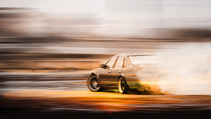 Double exposure sunset with car drifting, Blurred of image diffusion race drift car with lots of...