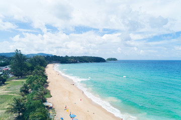 Beautiful tropical sea and wave crashing on sandy shore at karon beach in phuket thailand,aerial view drone shot.