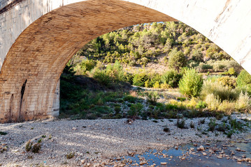 Roman bridge in Lagrasse in the south of France on a sunny day