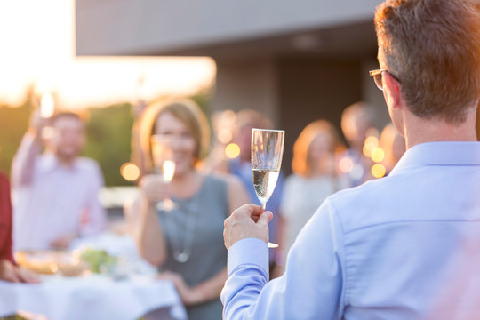 Business Colleagues Toasting Wineglasses During Rooftop Success Party