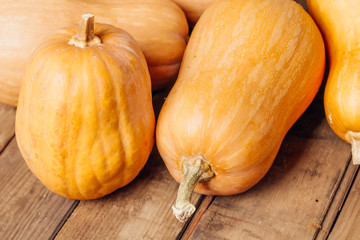 Autumn Pumpkin Thanksgiving Background - orange pumpkins over wooden table..fall season. autumn cozy still life.