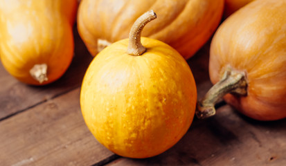 Autumn Pumpkin Thanksgiving Background - orange pumpkins over wooden table..fall season. autumn cozy still life.