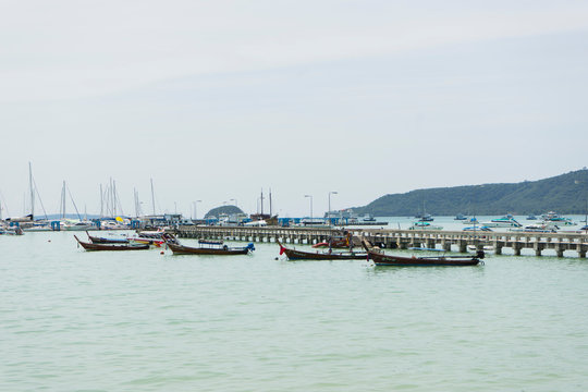 Fototapeta Many luxury yachts moored at Chalong Pier on sunny day in Phuket,Thailand
