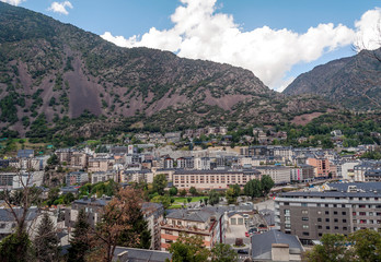 Obraz premium ANDORRA LA VELLA, ANDORRA - SEPTEMBER 2014. Anonymous people walking through the central streets of Andorra on a sunny day. It is a city surrounded by the mountains of the Pyrenees.